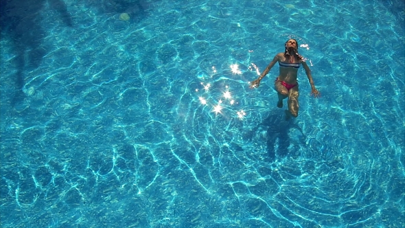 Young Woman Enjoying a Pool.