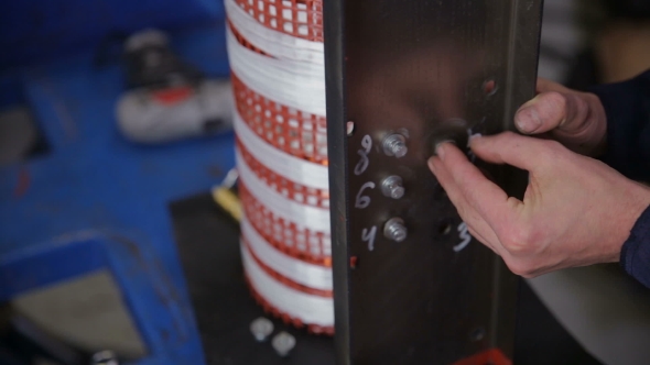 Factory Worker Assembling Electric Equipment - Transformer - On Assembly Line. High Voltage