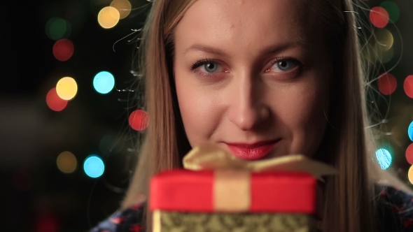 Happy Young Woman Holding Christmas Present Box