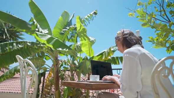 Rear View Freelancer Woman Working on Laptop Computer with White Empty Screen Over Mediterranean