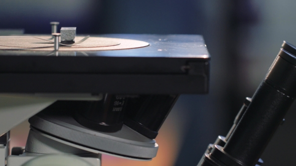 Scientist Looking Through a Microscope In a Laboratory. Young Doctror Diagnostic  Shot alt