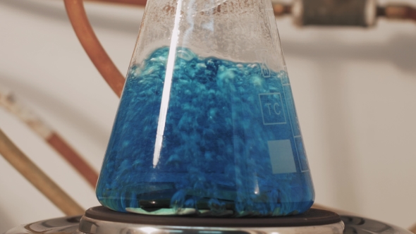 Chemist In Laboratory Holding Test Tube During The Reaction - Metal Iron Chemical Test