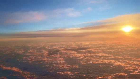 Aerial View of Amazing Sunset Over Floating Clouds