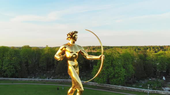 Golden Boy statue With Sun Clock Beneath