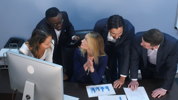 Multiracial group of cheerful business people discussing