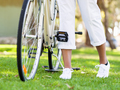 Happy young woman with bicycle - PhotoDune Item for Sale