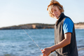 Teenage boy fishing at sea - PhotoDune Item for Sale