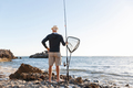 Senior man fishing at sea side - PhotoDune Item for Sale