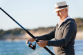 Senior man fishing at sea side - PhotoDune Item for Sale