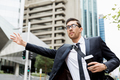 Young businessmen hailing for a taxi - PhotoDune Item for Sale