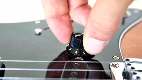 Wood grain electric guitar knobs, switches and pick guard.