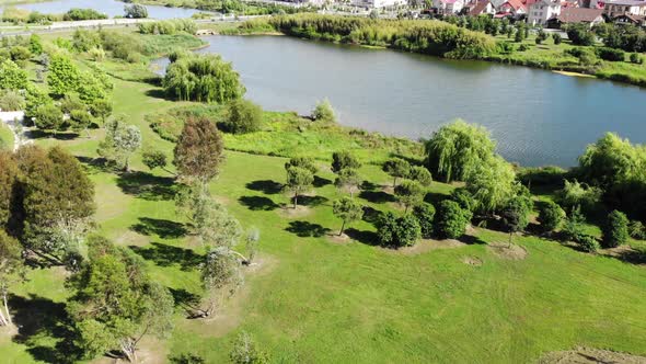 . AERIAL VIEW. The Lake in the Park in City. Sunny Day, Beautiful Scenery with a Lake in the Park.