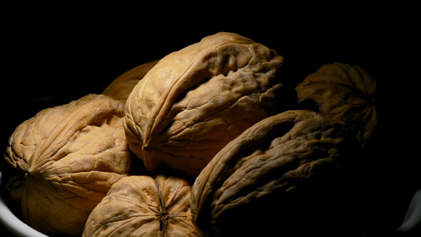 Walnuts Food in a Bowl Turning on Black Background