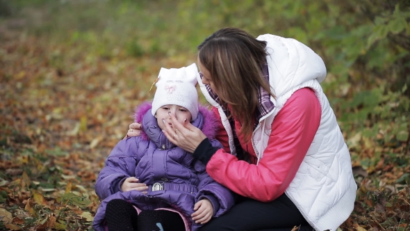 The Little Girl Crying In Autumn Park. Mother Comforting a Crying Child. Tears On The Cheeks