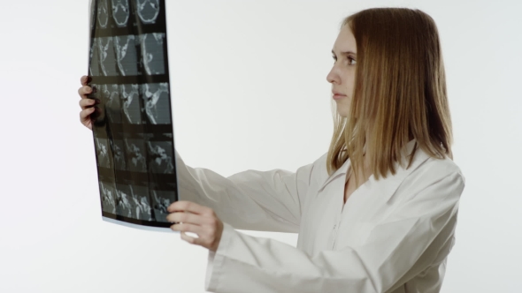 Female Doctor Looking At X-ray