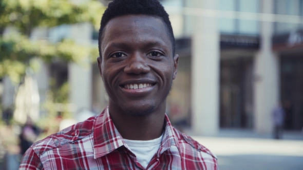 Afro-American Man Smiles And Looks Right At Camera