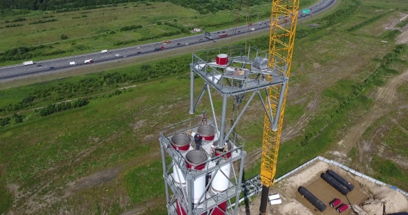 Workers On The Top Installs a Chimney Pipe For Gas Power Plant