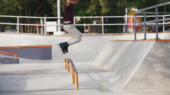 Aggressive Inline Roller Skater Doing Tricks in Concrete Skatepark Outdoors with Beautiful