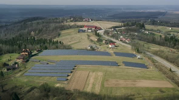 Solar Panels Stands in a Row in Field for Power Production.