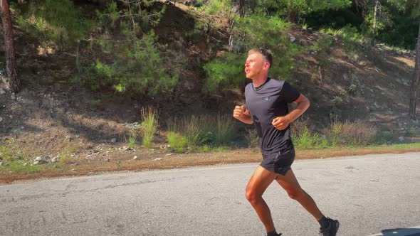 Man jogging outdoors at sunny morning