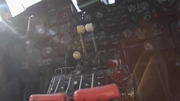 Old Helicopter Cabin with Black Instruments Panel, Dashboard and Steering Wheel.