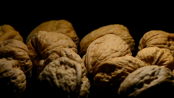 Walnuts Nuts Turning on Black Background