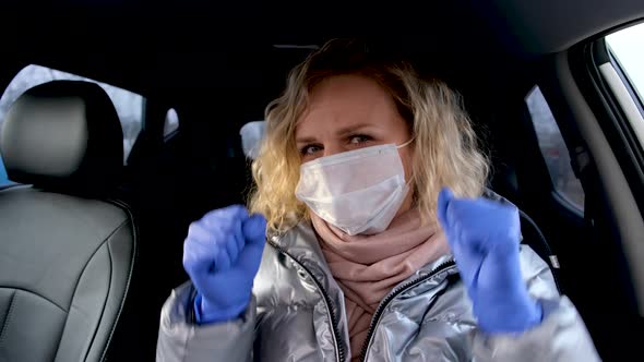 Curly Blonde Girl Driver Putting on Medical Mask and Protective Gloves Dancing in Car Before Driving
