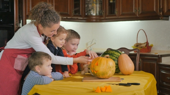 Three Children And Mother Preparing To Halloween