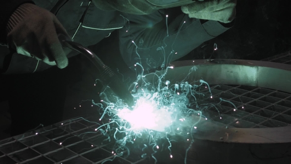 Welder Industrial Automotive Part In Factory, Hot Metal Welding On Modern Workshop With Sparkles