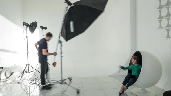 Photographer And Model Working In Studio