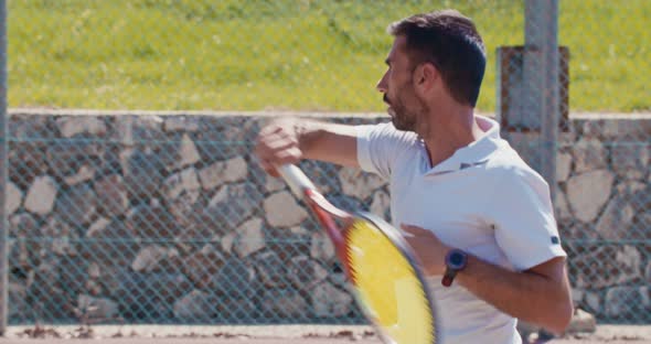 Slow motion of a tennis player hitting the ball during a tennis game