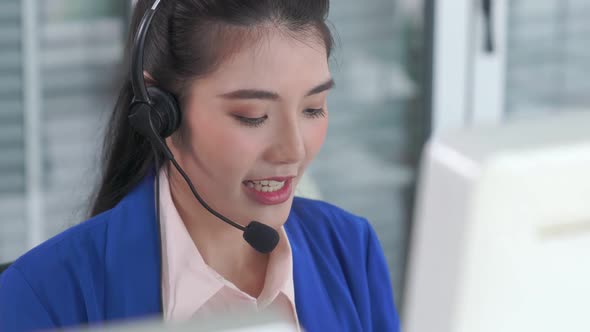 Businesswoman Wearing Headset Working Actively in Office