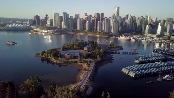 Downtown Skyline Of Coal Harbour And Deadman's Island From Brockton Point At Stanley Park In Vancouv