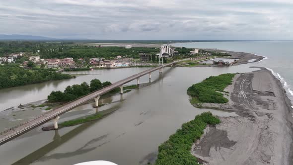 Anaklia, Georgia - July 16 2022: Aerial view of Anaklia-Ganmuhkuri Pedestrian Bridge at sunset