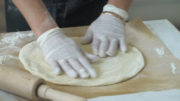 Cook Rolls Out The Dough For Focaccia