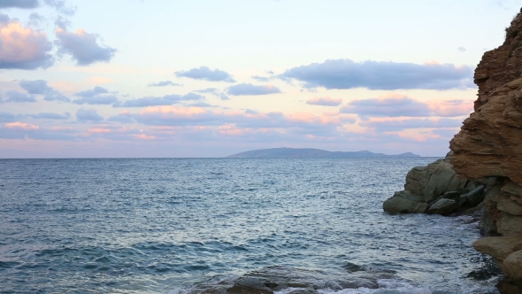 Sea Waves Crashing Into Rocks At Sunset