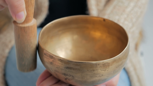 Young Woman In Cardigan Relaxing With Nepal Singing Bowl