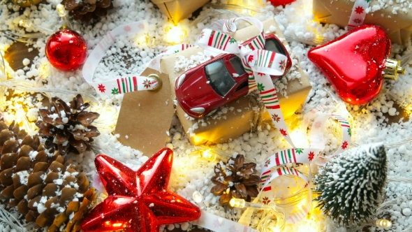 Christmas And New Year Background With Toy Car, Presents, Ribbons, Balls And Different Green