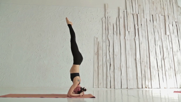 Young Sporty Woman Practicing Yoga In Fitness Studio