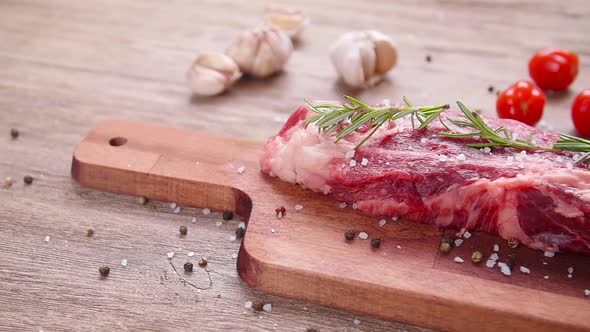 Cooking Concept. Raw Beef Steak on a Wooden Table.