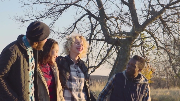 Happy Diverse Group Walking On Dirt Path