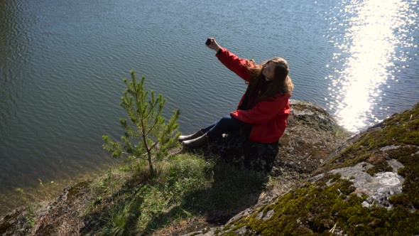 Asian Girl Doing Selfie Smartphone on the Lake