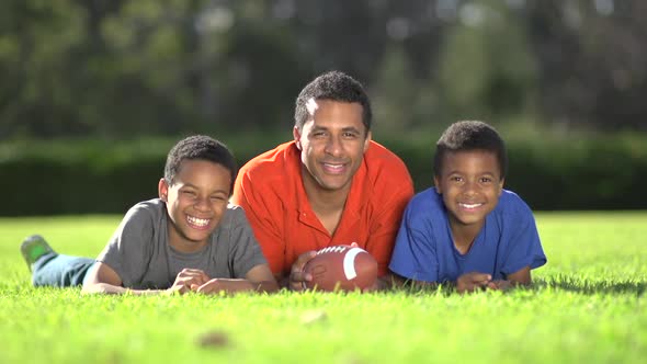 Group portrait of a father and his sons with a football