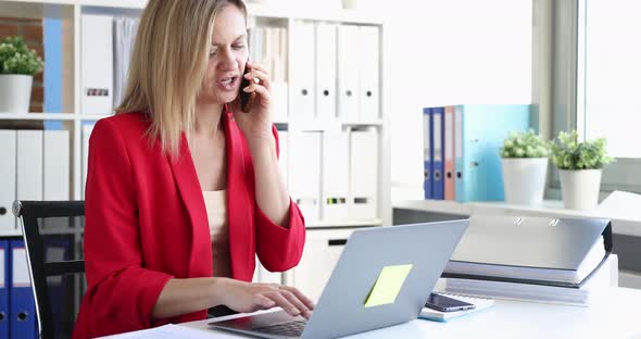 Businesswoman is Talking on a Smartphone and Working on Computer in Office  Movie