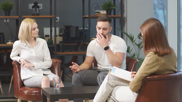 Healthcare Concept: Young Caucasian Couple Visit Professional Psychologist Doctor