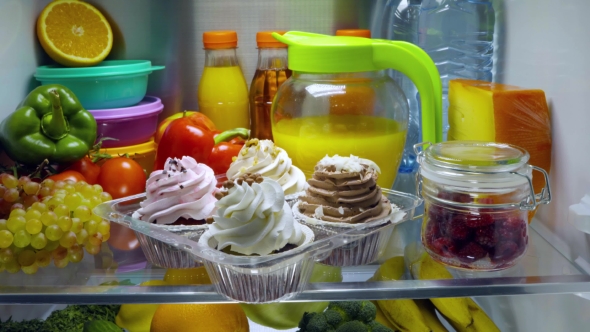 Sweet Cakes In The Open Refrigerator