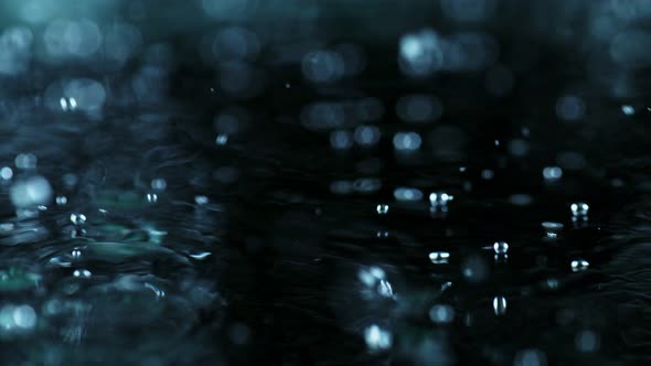 Super Slow Motion Shot of Many Water Drops Falling and Splashing on Surface at 1000Fps