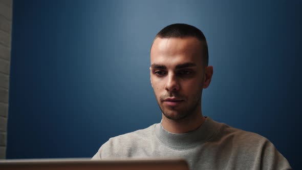 Focused Caucasian Businessman Work and Typing on a Laptop. Young Male Professional Using Laptop