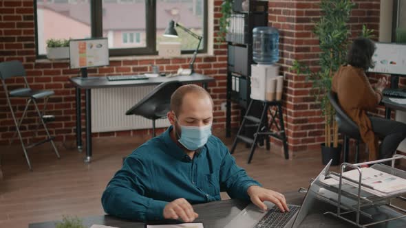 Entrepreneur Wearing Face Mask and Working on Business