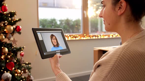 Woman with Tablet Pc Has Video Call on Christmas